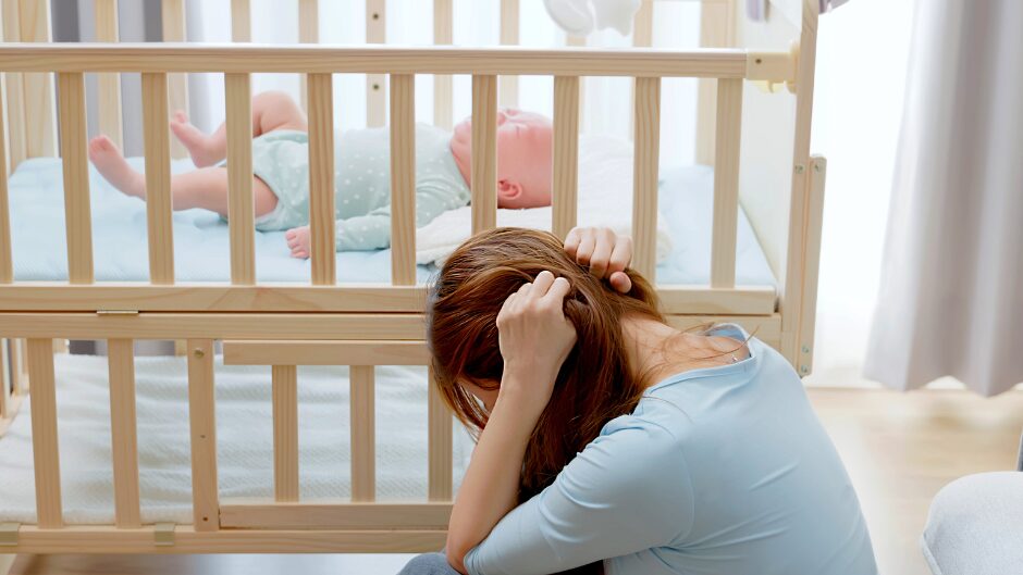 産後のストレスで頭をかかえる女性